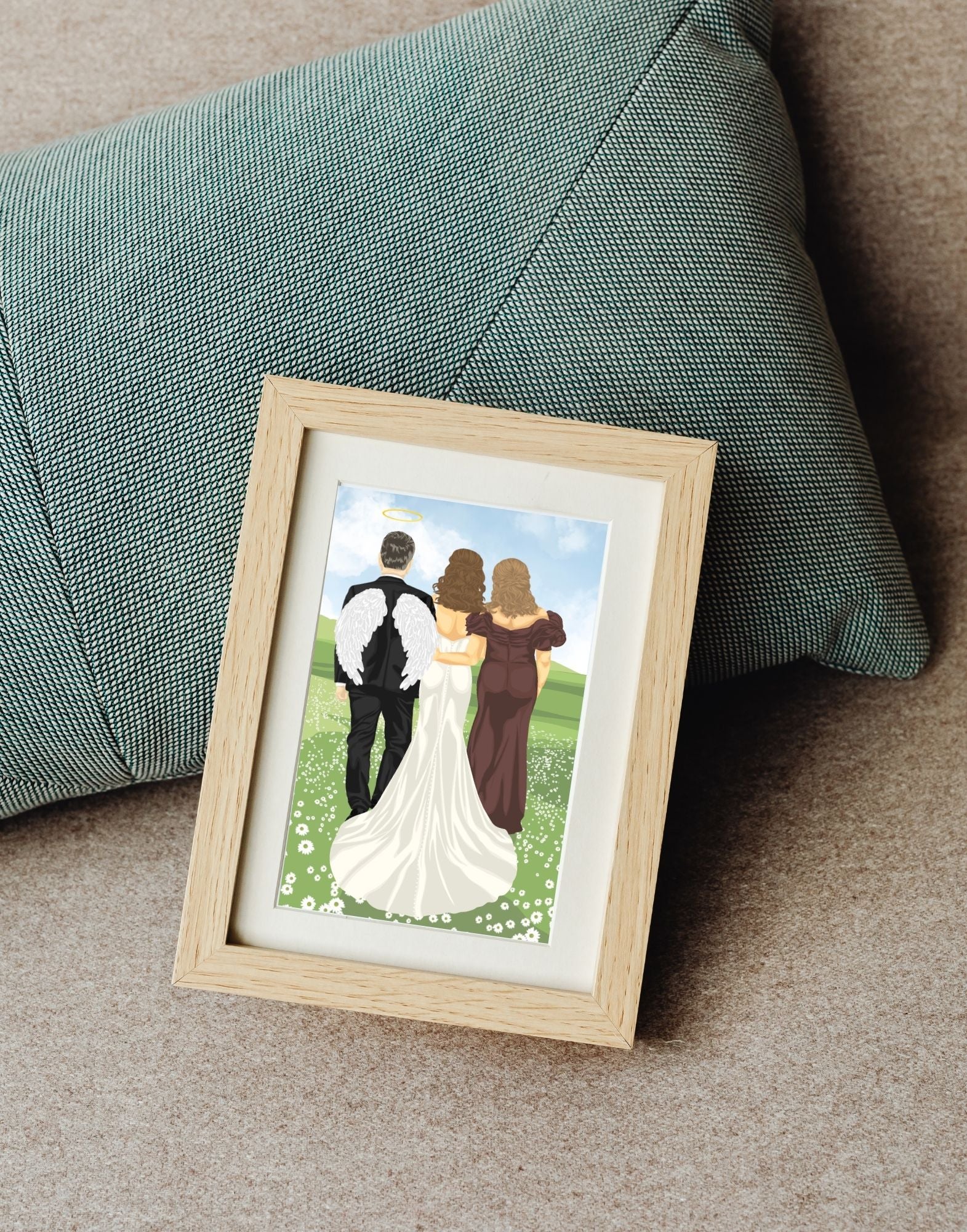 Framed artwork of a bride with parents walking on a grassy field with a green pillow in the background
