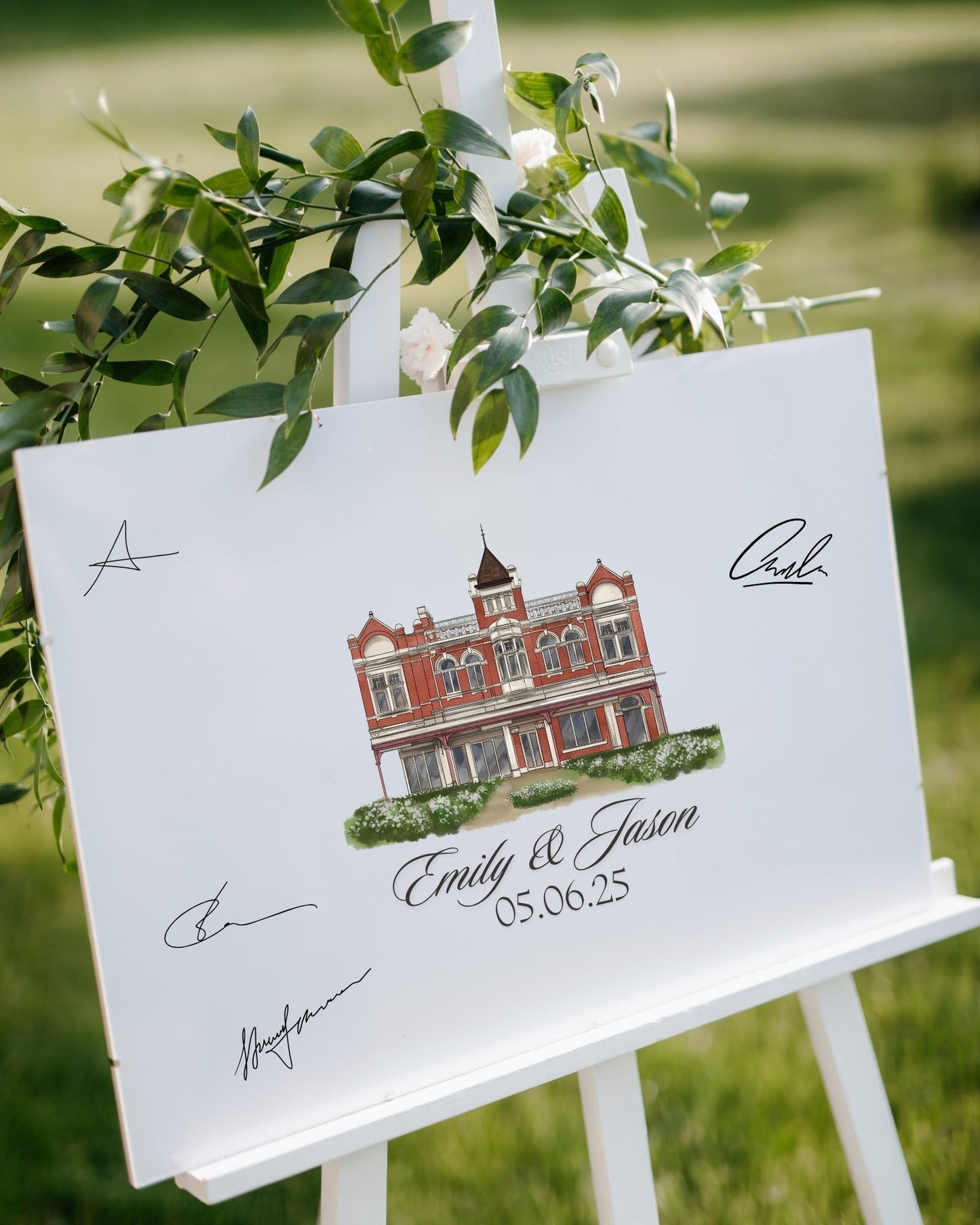 Guest book with a drawing of a building and personalized text on an easel outdoors.